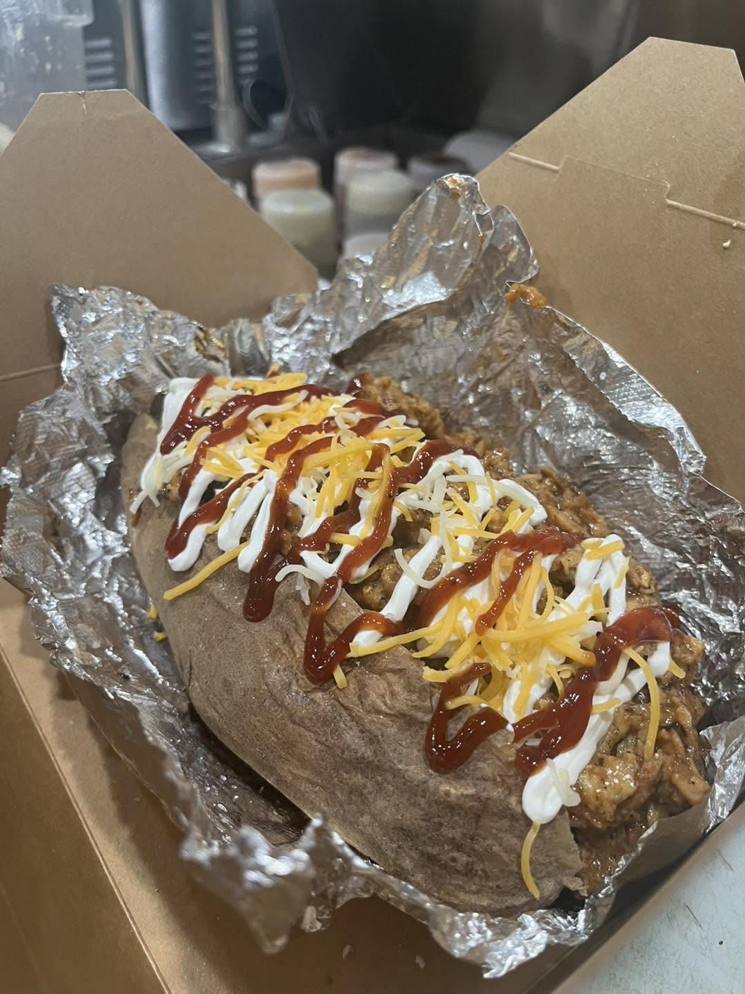 Build Your Own Big Ass Potato with chicken, barbecue sauce, sour cream and cheese